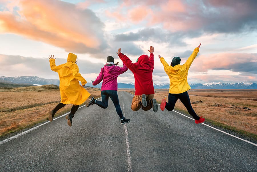 Friends jumping on the road in Iceland