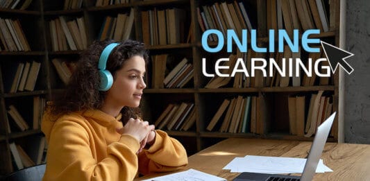 A girl in a library doing an online course