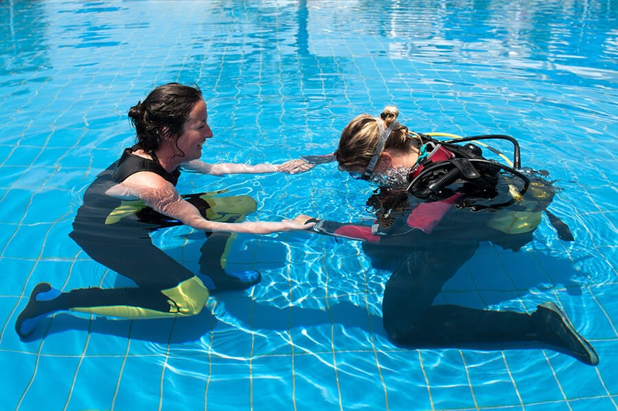 Scuba diving instructor and student in a swimming pool