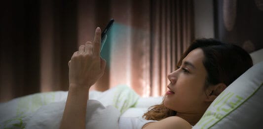 Woman using device before sleep