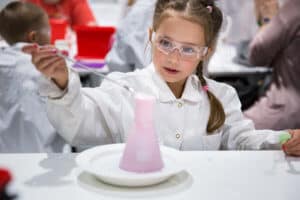 A little girl working on chemical experiment