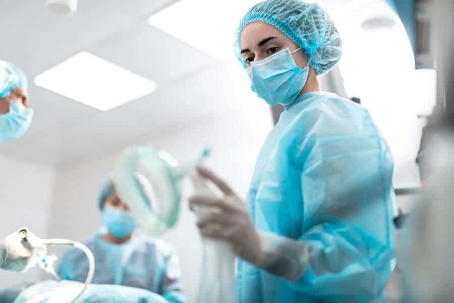 Young surgical nurse holding respiratory equipment for patient