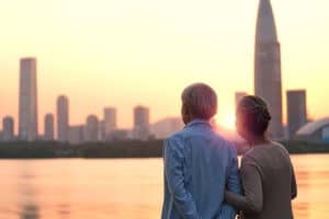Senior couple looking at sunset and city skyline of Singapore