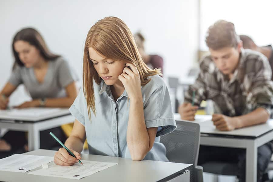 Student doing exam at classroom