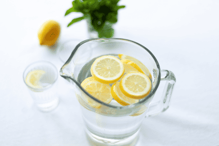 A pitcher with water and lemons