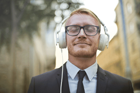 A person wearing headphones and smiling