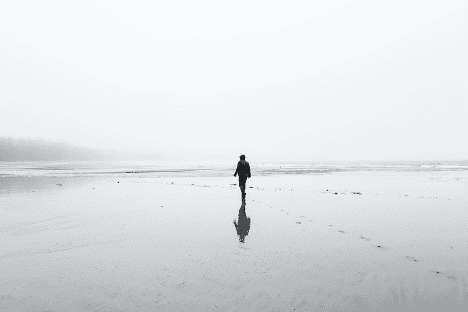 A person walking on the beach alone.