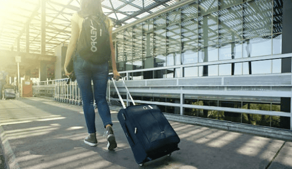 A person carrying a suitcase.